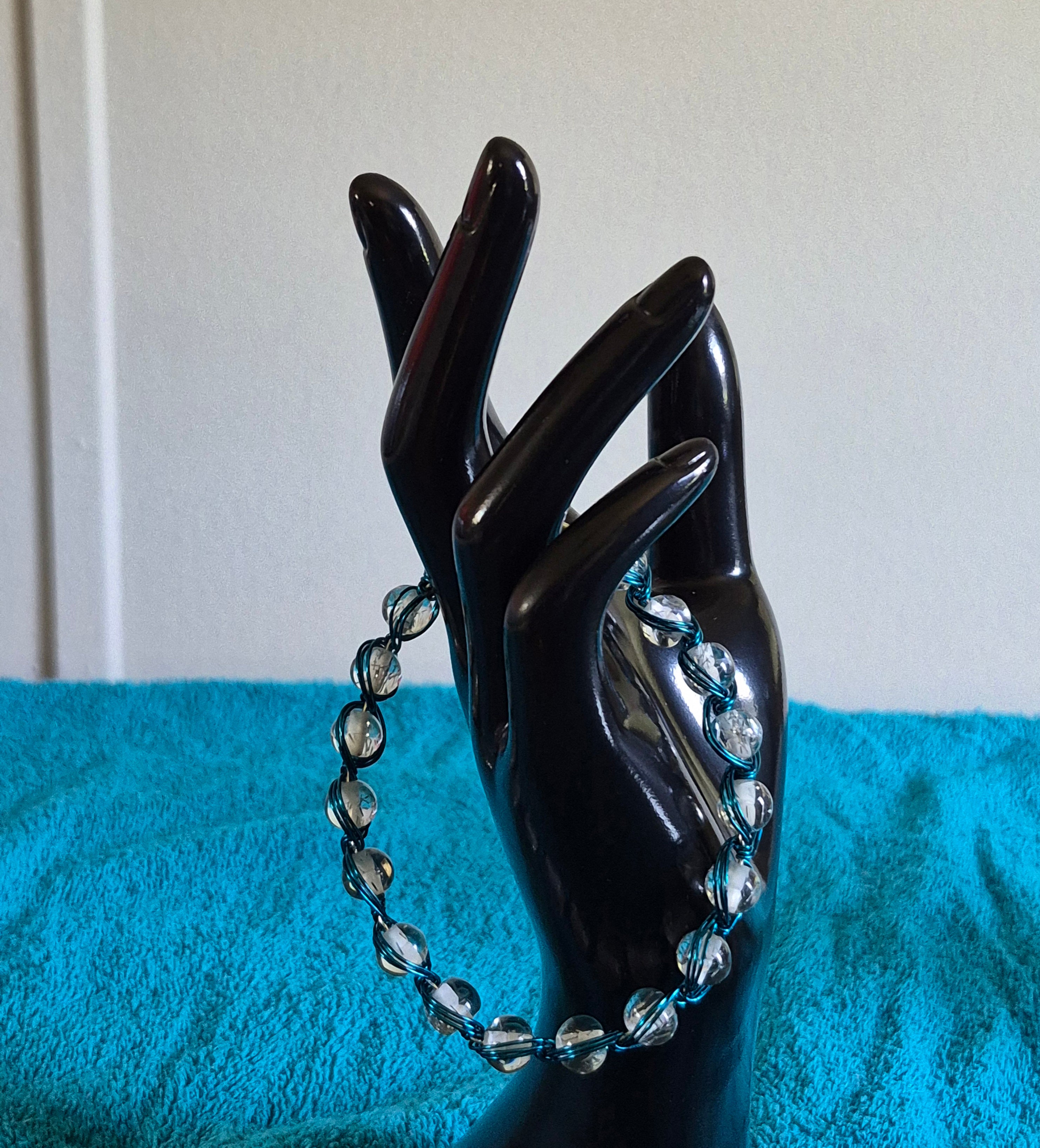 Clear bead wrapped in blue wire